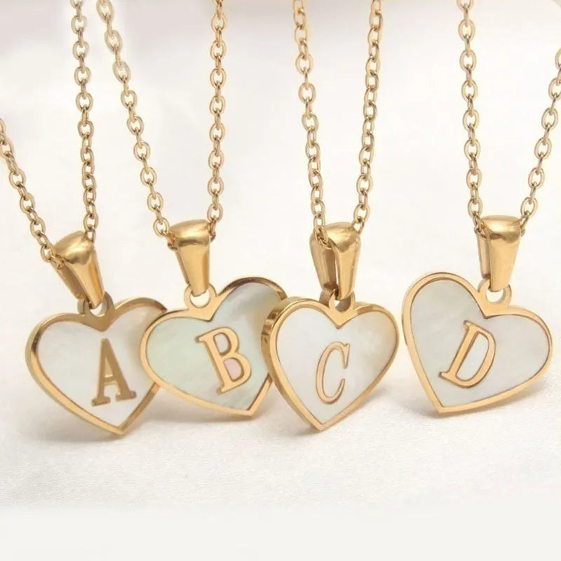 Gold plated heart pendant necklace with white shell centre and personalised letter engraving on adjustable chain
