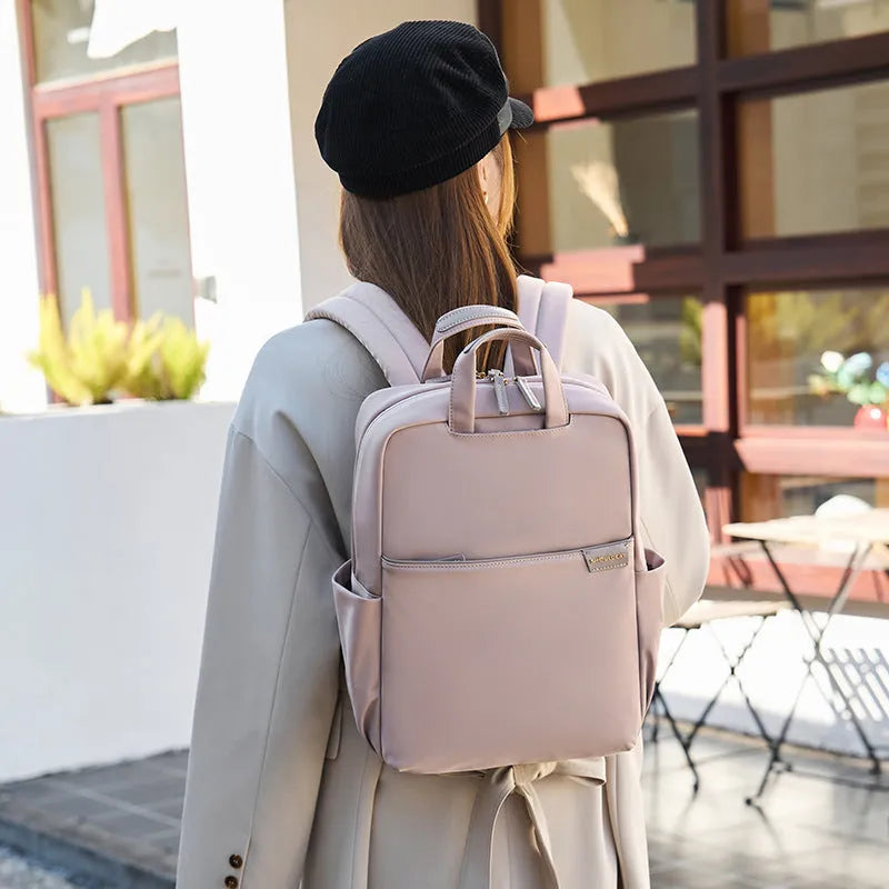 Women's large capacity canvas travel backpack in apricot colour showing external pockets and internal laptop compartment.