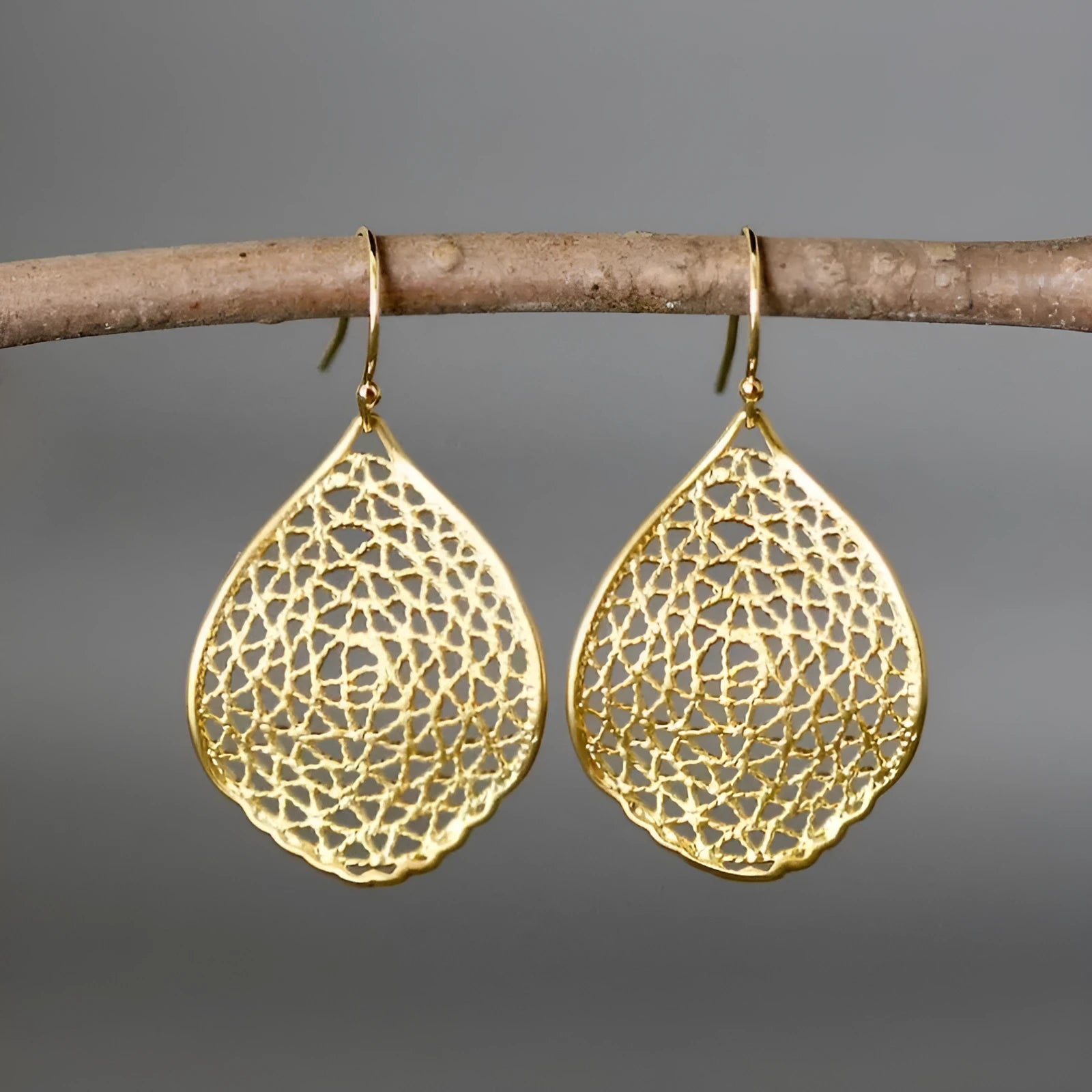 Gold alloy drop earrings with retro leaf hollow pendant design