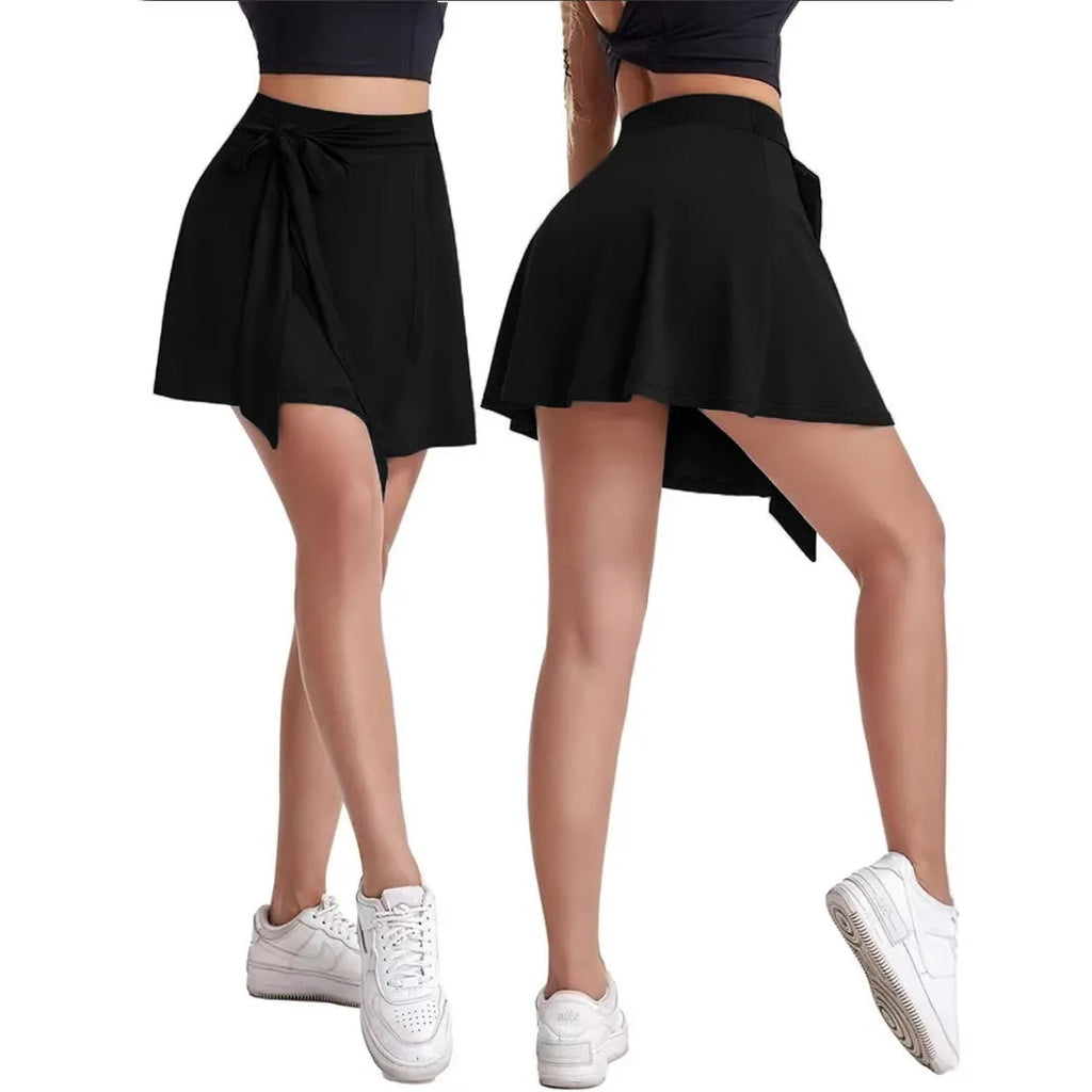Black thigh-length sports skirt with attached shorts, showing high waist and shoulder strap details.