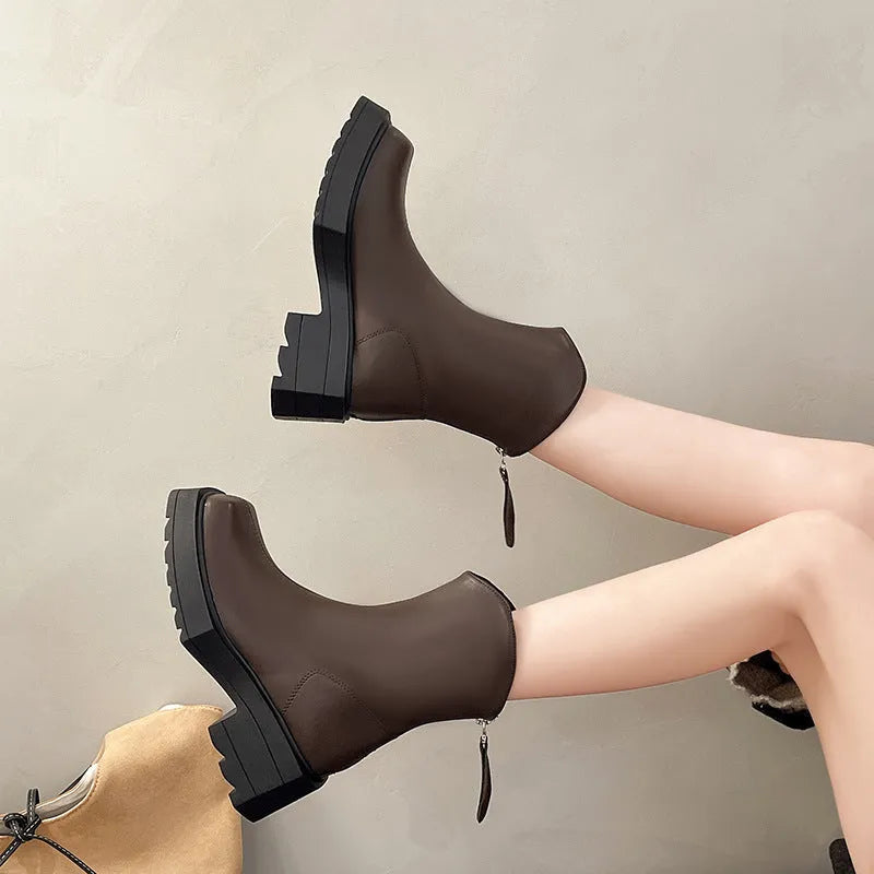 Women's black square-toe platform Martin boots with a block heel and rear zip on a white background