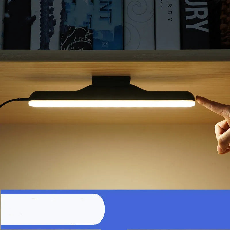 Modern plastic LED desk lamp with touch controls and built-in battery on wooden desk