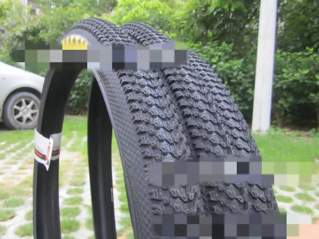 Ultralight puncture-proof mountain bike tyre shown in multiple sizes including 26, 27.5 and 29-inch options.