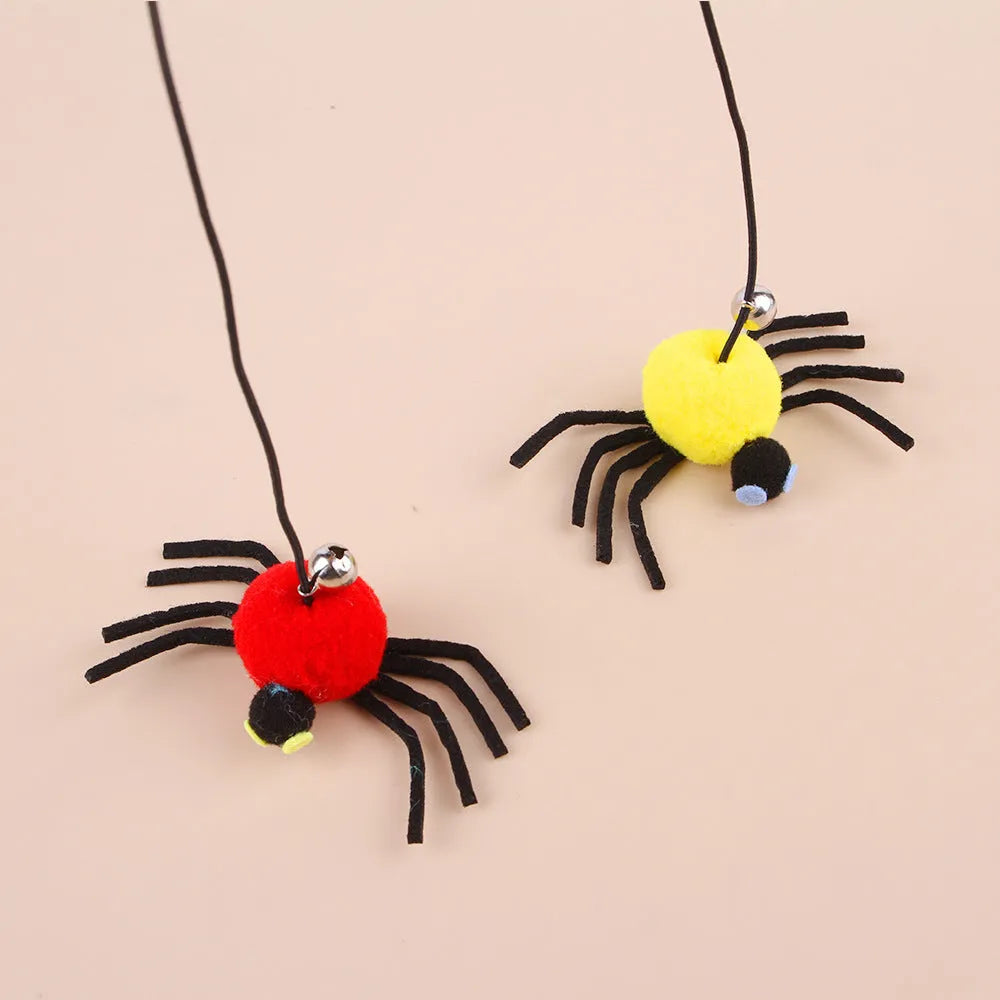 Red and yellow hanging cat toy with elastic rope, feathers, and a bell spider attached to a door.