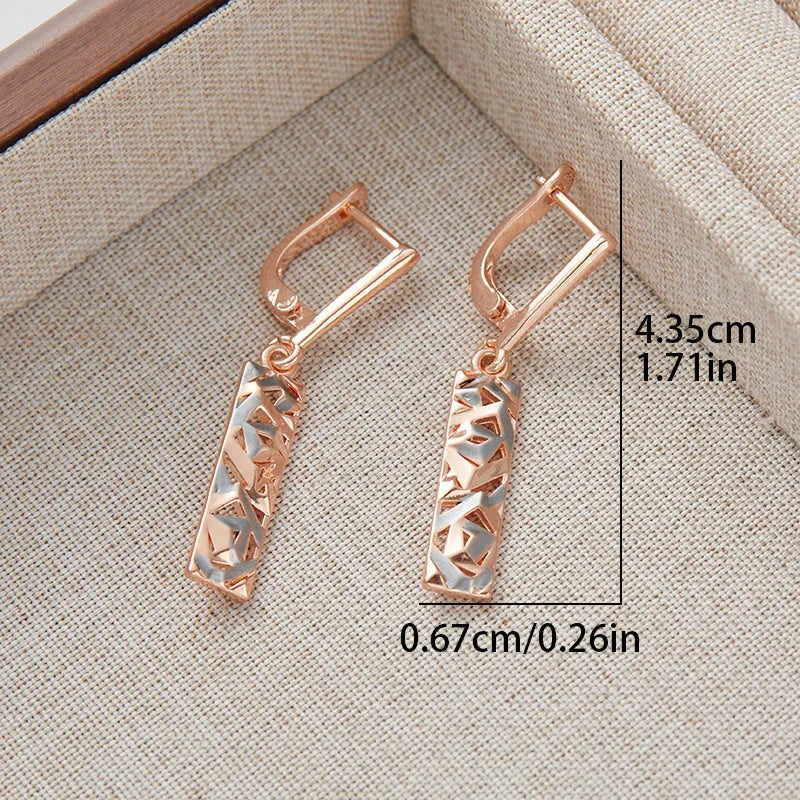 A pair of geometric hollow two-tone stud earrings with a rectangular shape and electroplated alloy finish.