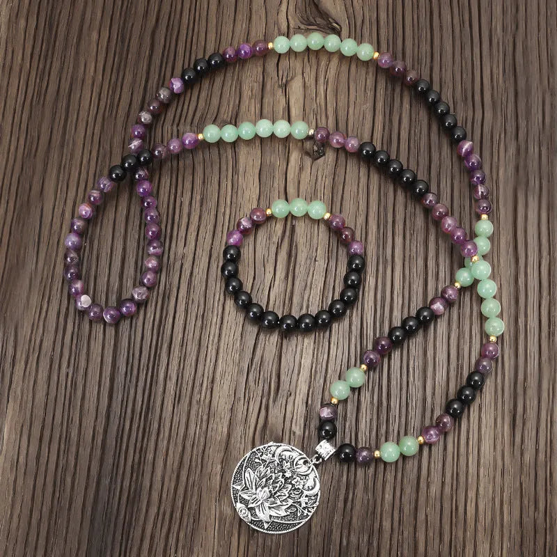 Handmade yoga necklace with lotus pendant and stone beads alongside matching bracelet