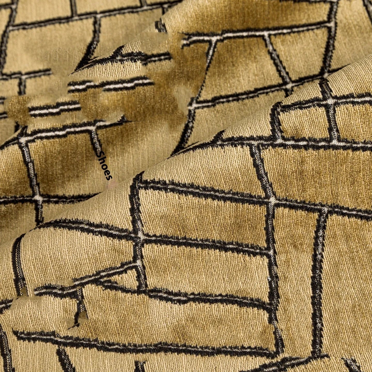 Gold geometric pattern decorative cushion cover on a grey sofa
