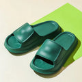 A pair of thick-soled, soft EVA flip-flop slippers with a non-slip tread pattern.
