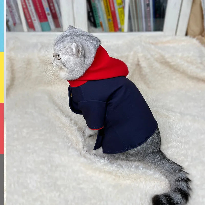 A dog or cat wearing a hoodie photo prop in a tiger staff pattern design.