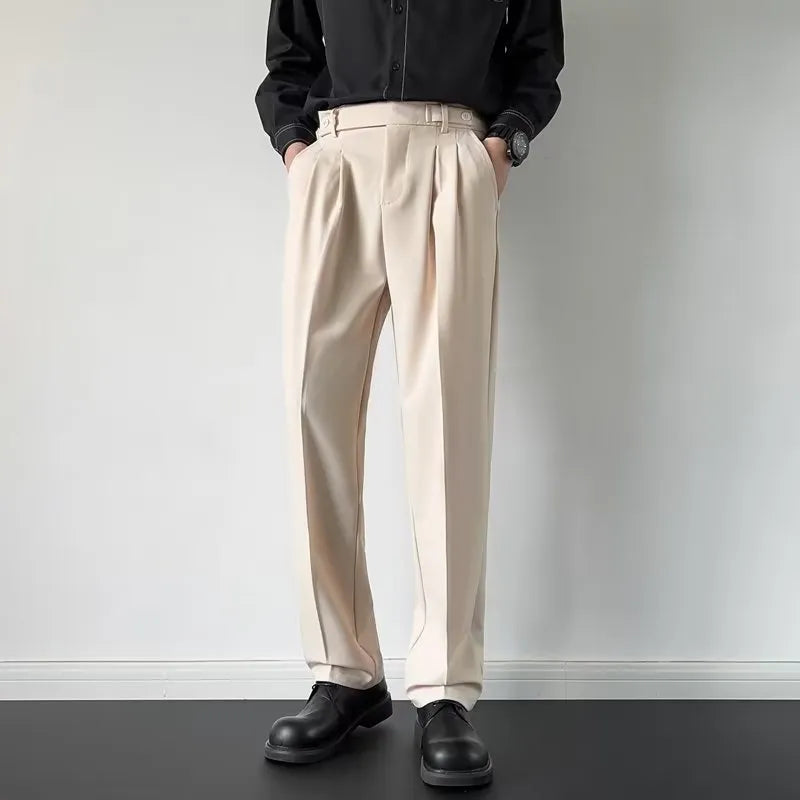 Men's straight loose fit suit trousers in apricot colour, laid flat.