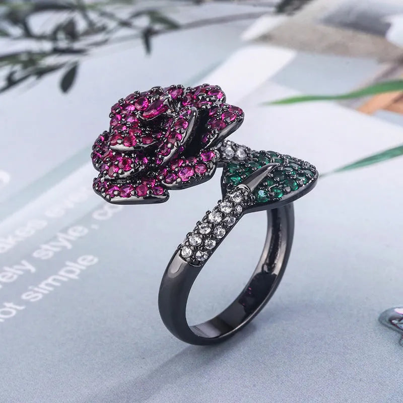 Black gold geometric flower ring with simulated red corundum centrepiece on copper base