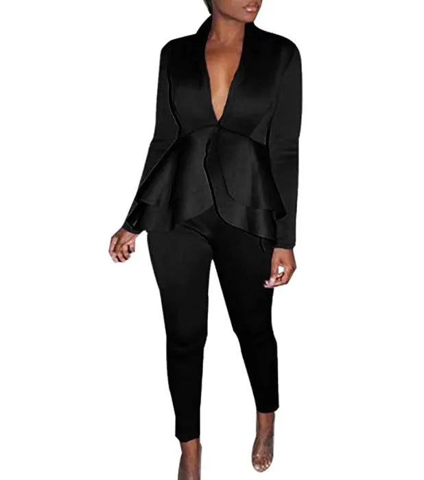 White ruffled business casual shirt and matching pencil pants set laid flat.