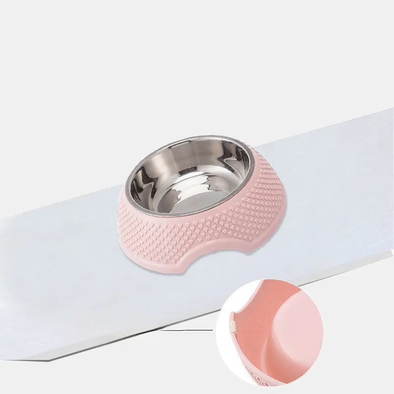 Blue stainless steel pet bowl with a non-slip black base on a kitchen floor.