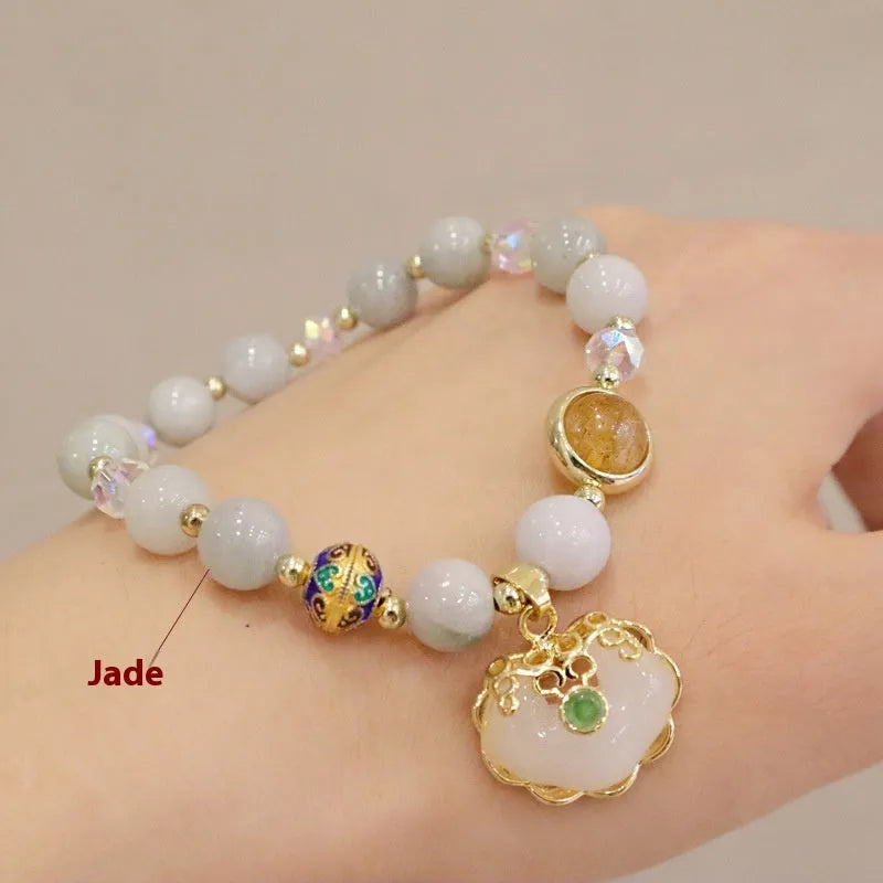 Geometric ethnic bracelet with natural jade, strawberry quartz stones and metal decorations