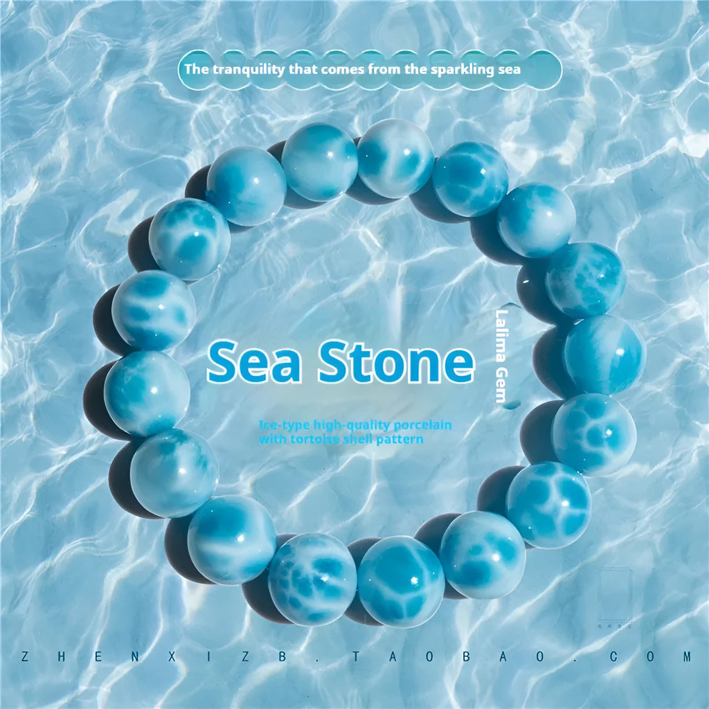 Blue Maillard-style bracelet with bodhi beads, natural crystal stone, and pearl accents on a wrist.