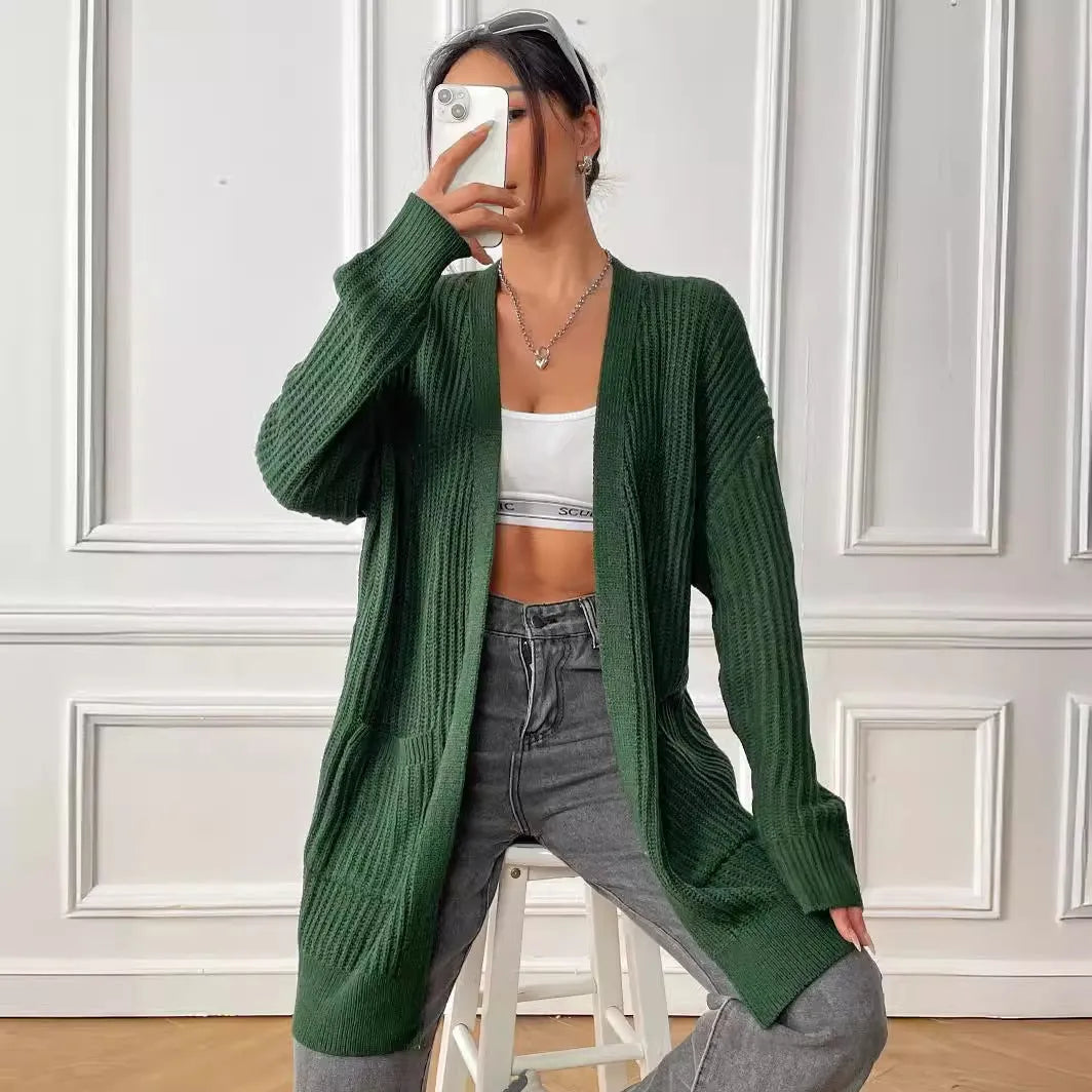 Women's dark green loose fit acrylic cardigan sweater with double pockets and long sleeves.