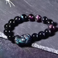 Natural ice colour eye obsidian crystal bracelet showing polished beads with characteristic banding patterns