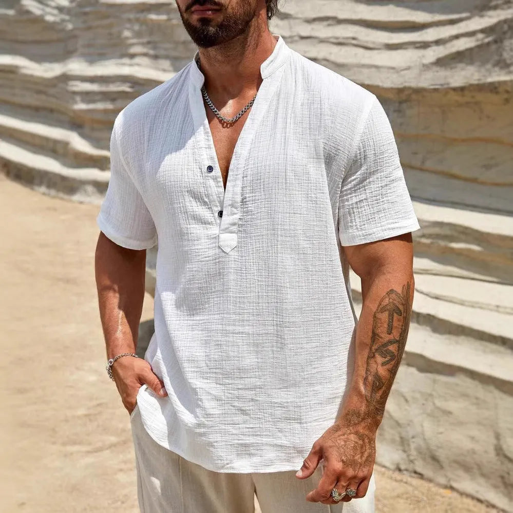 Man wearing a solid colour short sleeve casual shirt with a stand collar.
