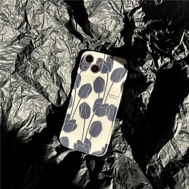 Black silicone iPhone case with a tulip flower design on the back.