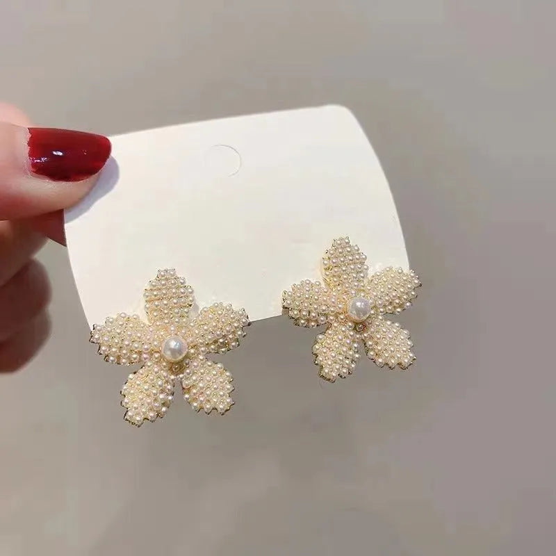 Women's gold electroplated alloy drop earrings with pineapple design and starfish pearl, featuring inlaid stones.