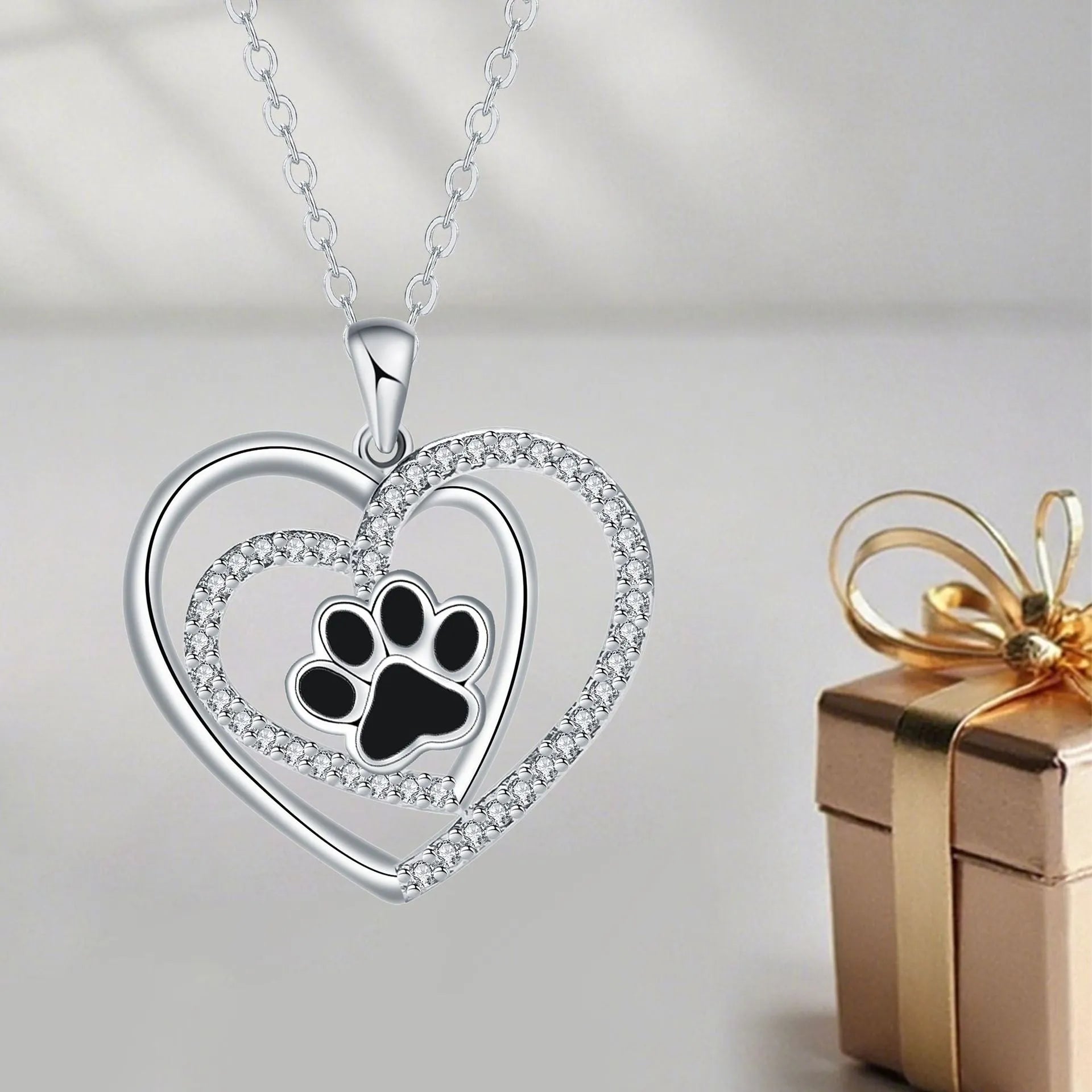Women's copper heart-shaped pendant necklace with detailed dog's paw prints and cross chain