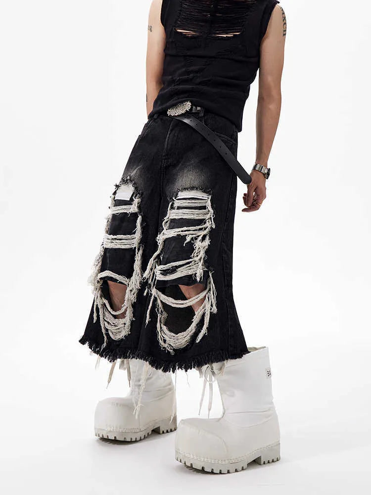 Women's black cropped wide leg jeans with ripped patch details and mid-high waist
