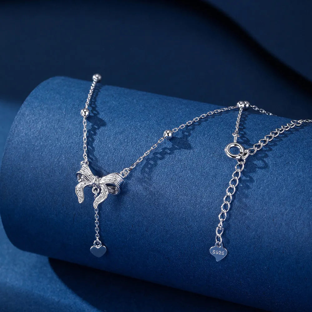 Silver butterfly heart pendant necklace with bow detail on O-ring chain