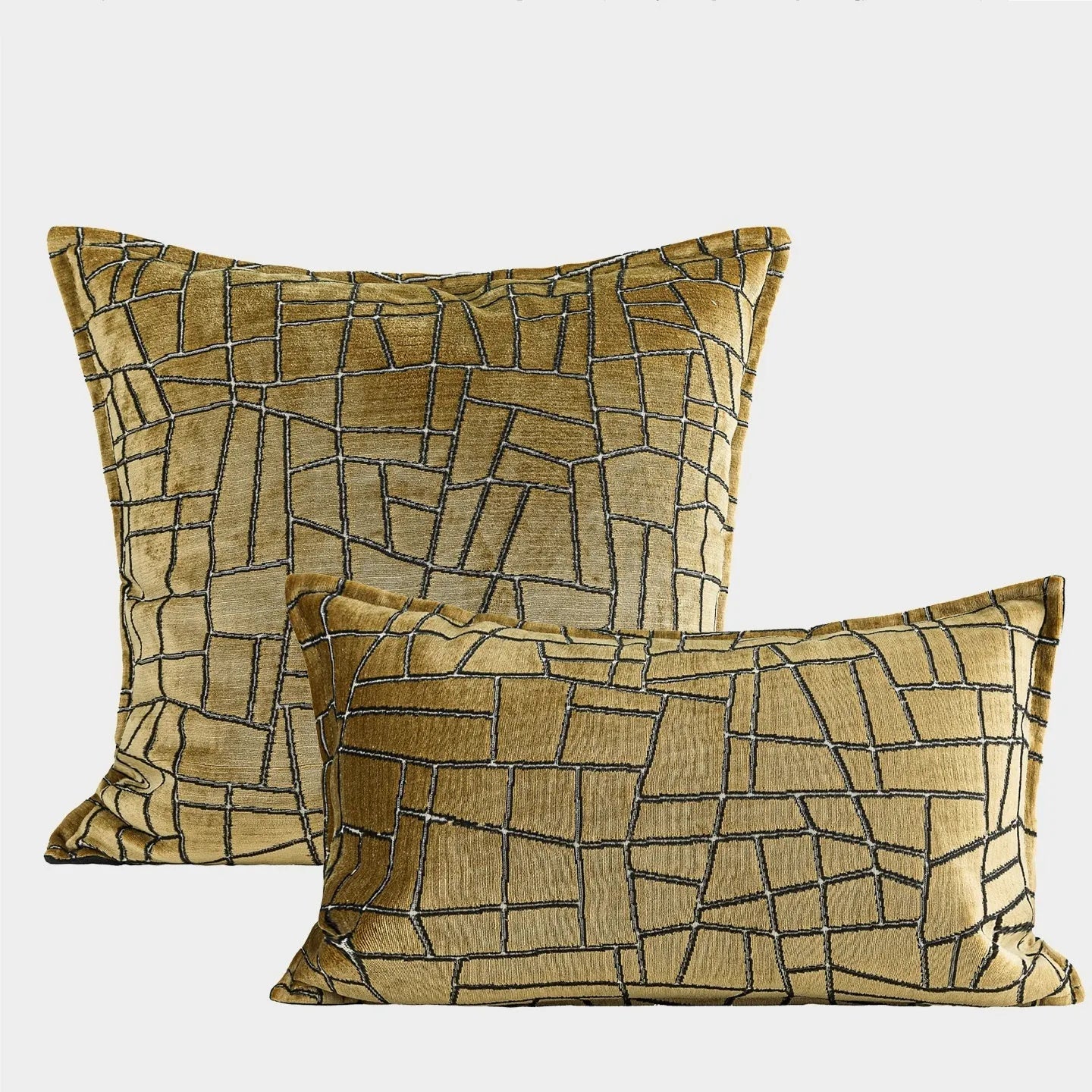 Gold geometric pattern decorative cushion cover on a grey sofa