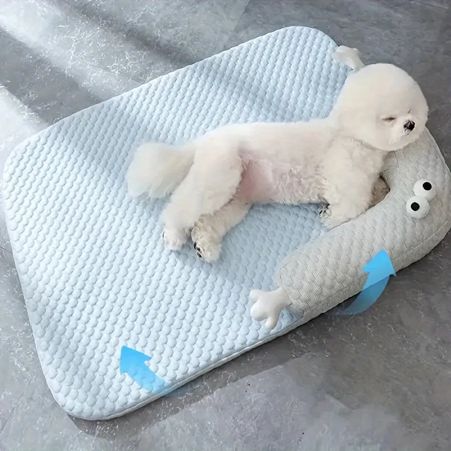 Blue and yellow big-eyed monster design pet bed cushion for dogs and cats on a wooden floor.
