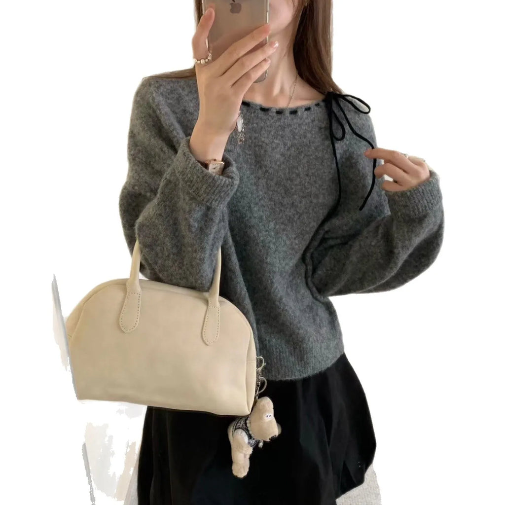 Grey loose-fitting women's knitwear pullover jumper on a hanger.