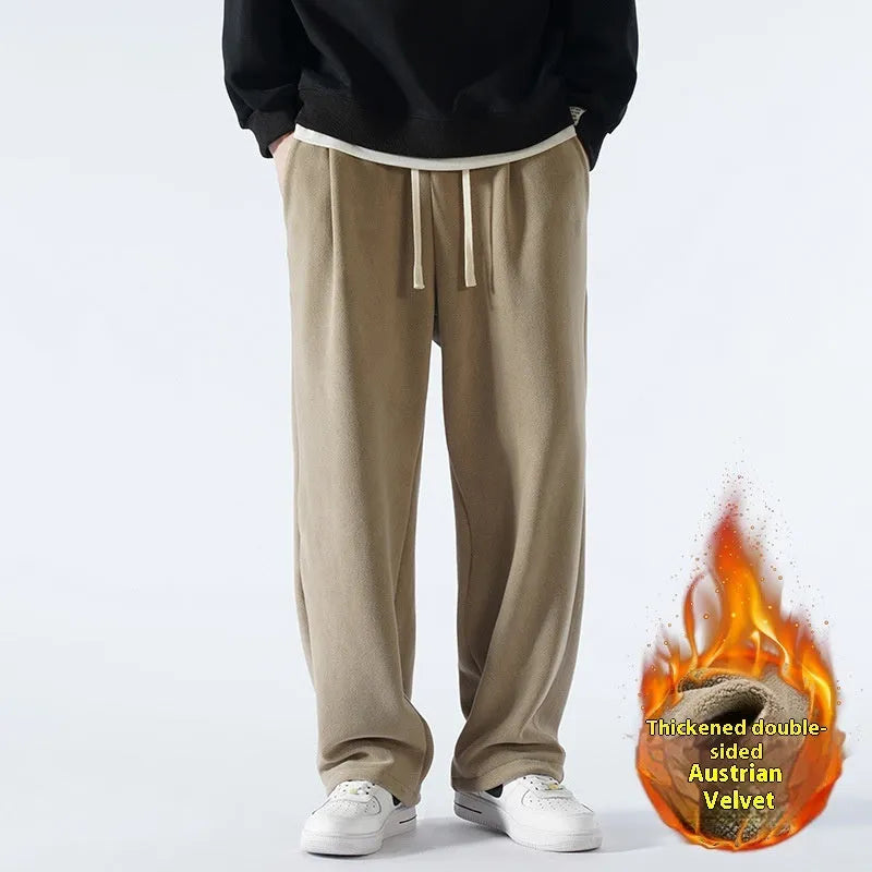 Men's double-sided polar fleece winter sports trousers in apricot colour, showing loose fit and drawstring waistband.