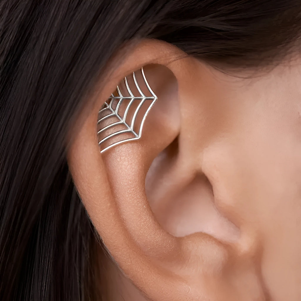 Geometric spider web stud earrings in gold and silver electroplated metal.