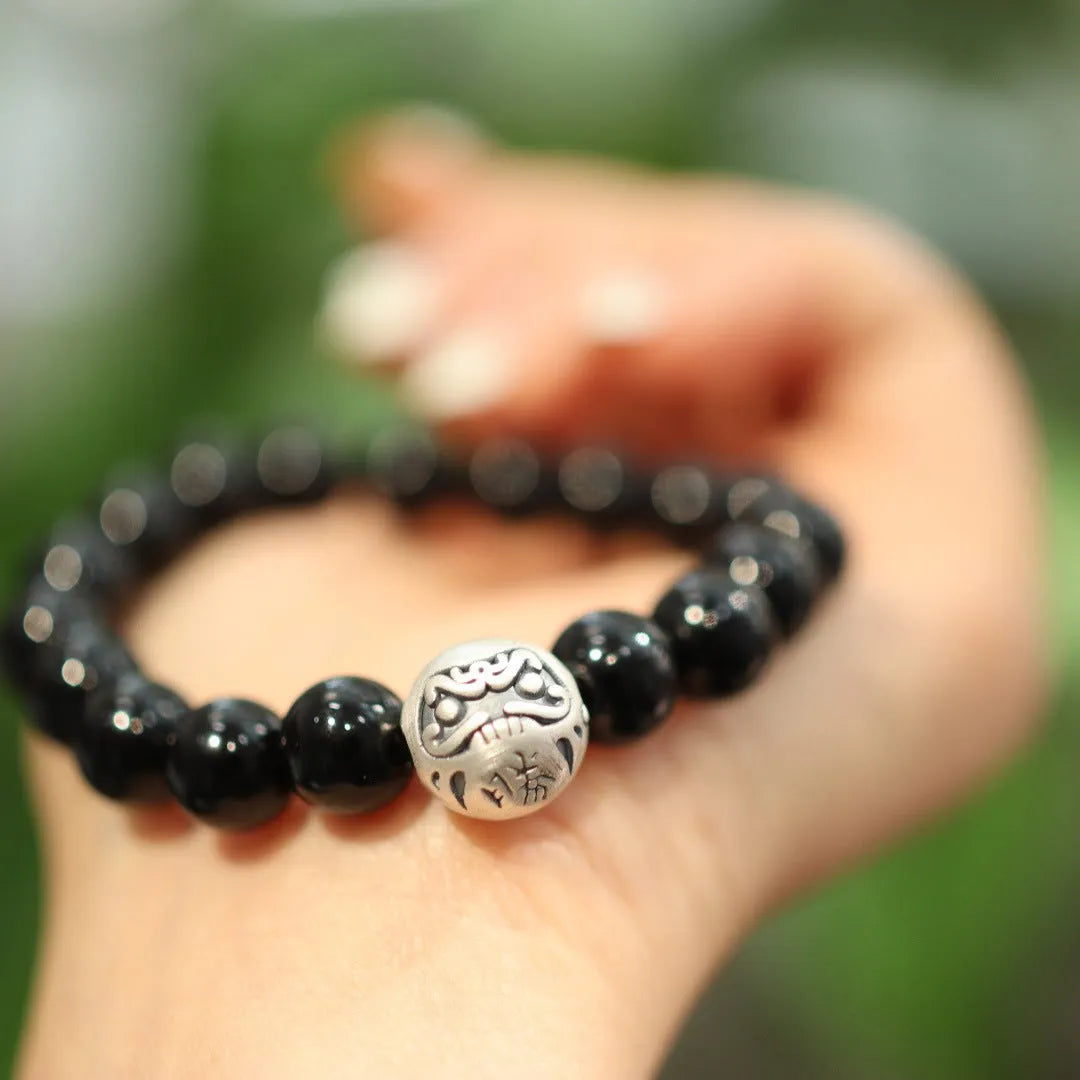 Close-up of a women's bracelet with a 10mm black agate stone and Chinese-style sterling silver and alloy design.