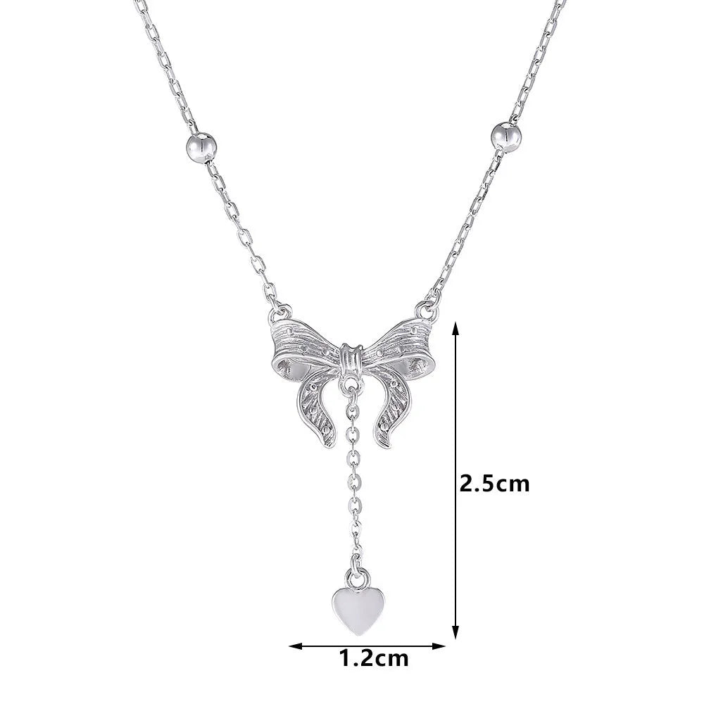 Silver butterfly heart pendant necklace with bow detail on O-ring chain