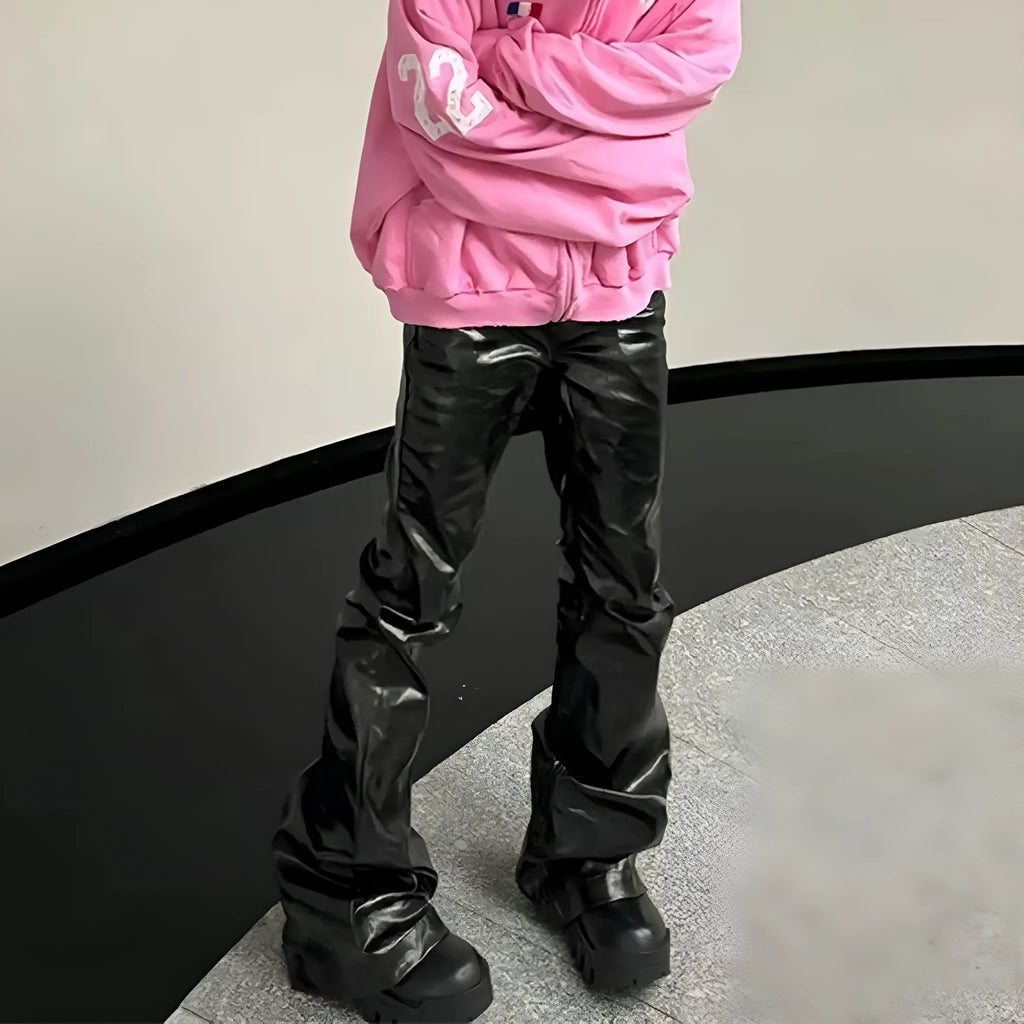 Black coated skinny jeans with a shiny patent leather finish and straight leg cut.
