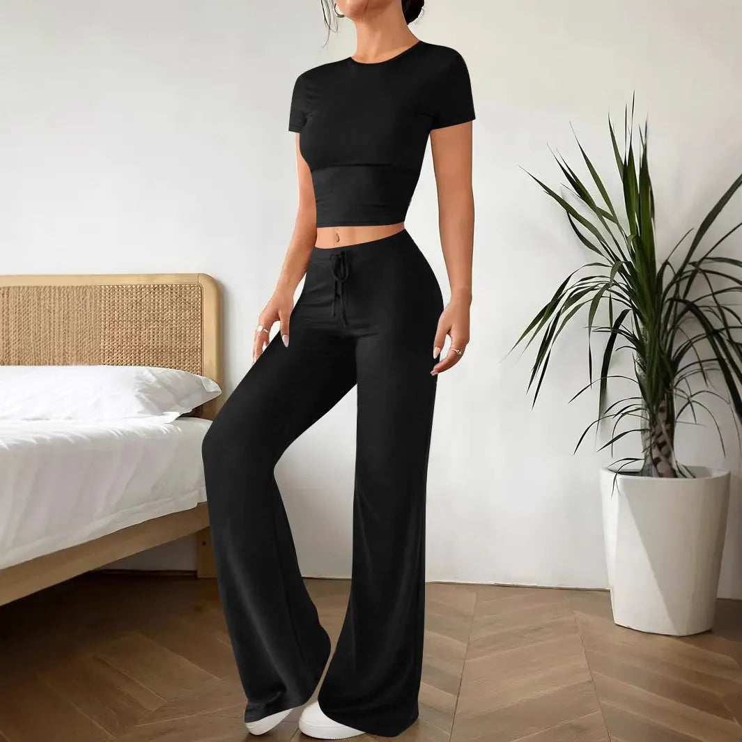 Black women's high waist trousers and short sleeve t-shirt co-ord set on a hanger.