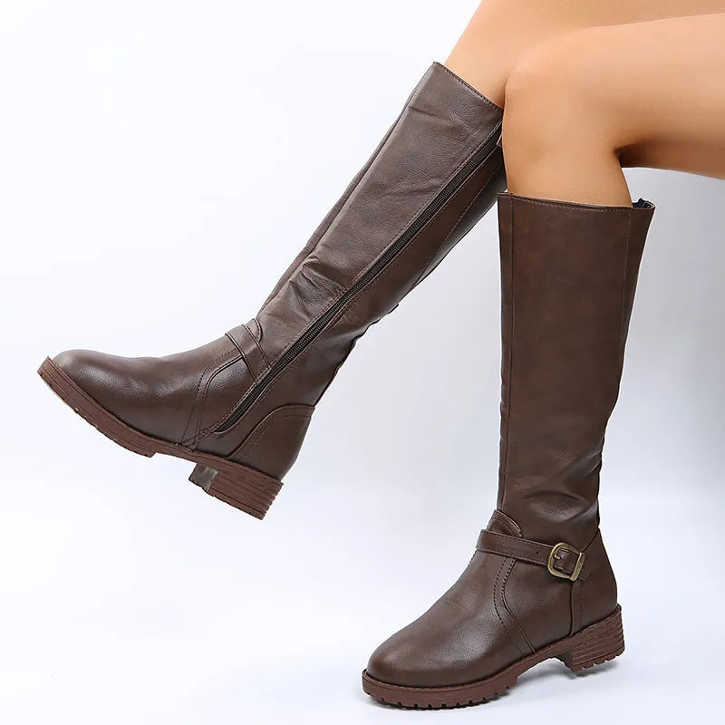 Women's knee-high knight boots in black with a square heel and a silver belt buckle detail on the side.