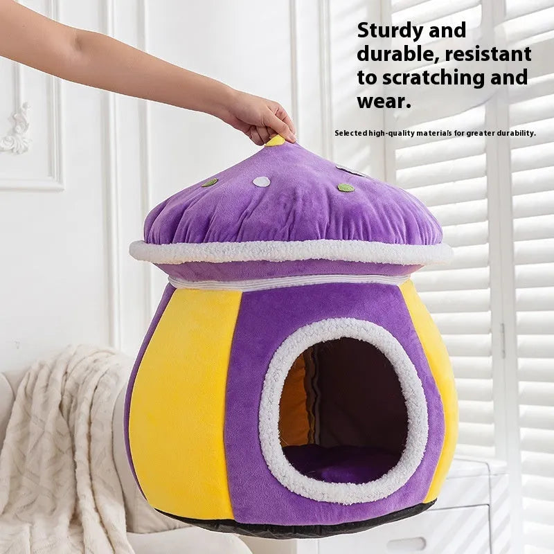 Purple mushroom-shaped plush cat nest with a detachable blanket, shown on a wooden floor.