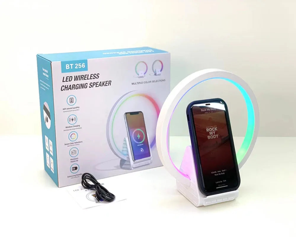 White circular smart Bluetooth speaker with ambient lighting and wireless charging pad