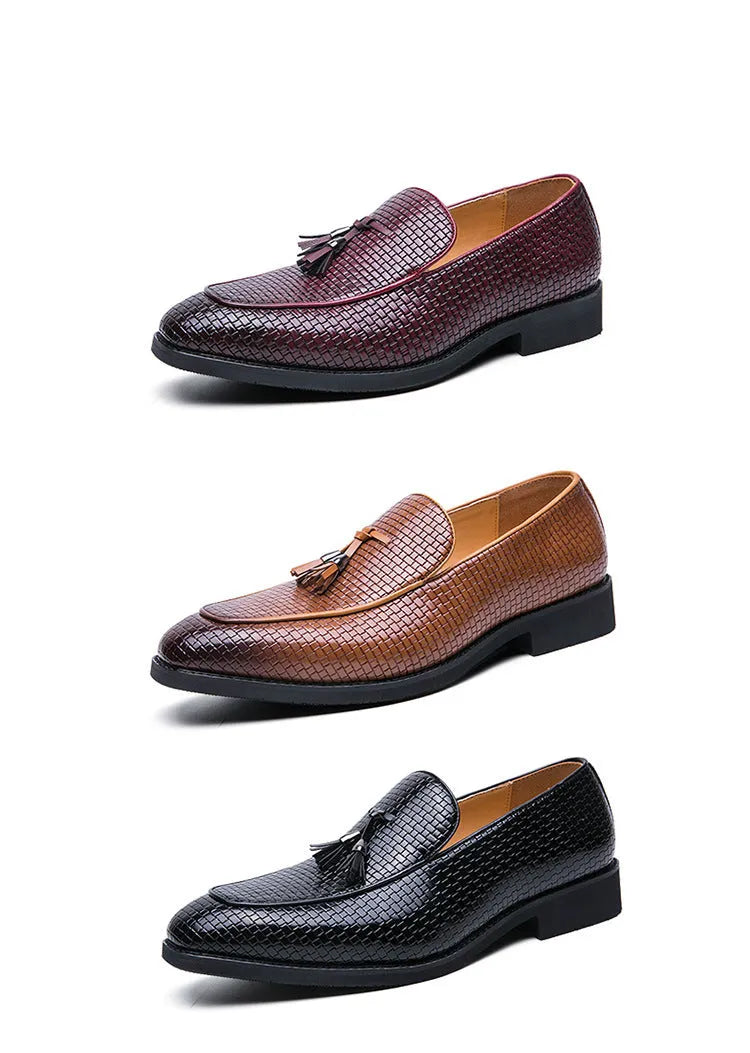 Men's black pointed toe slip-on shoes with a tassel detail on the front.