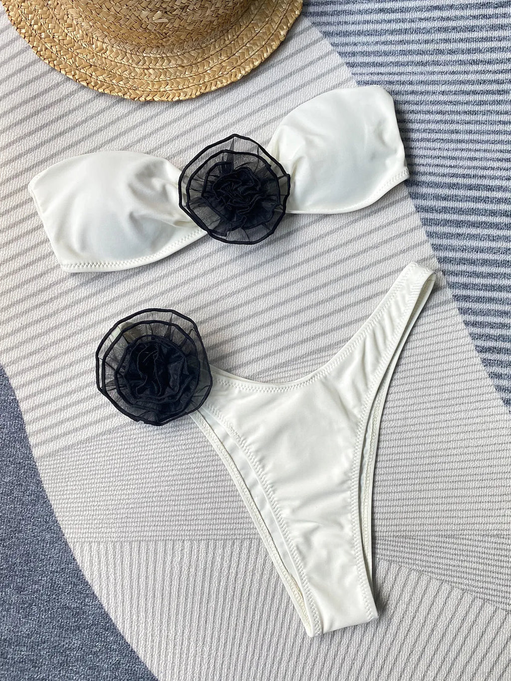 Striped split design bikini swimsuit with cross-back top and three-dimensional flower detail.