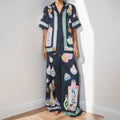 Black women's cardigan and pants set with cartoon animation print.