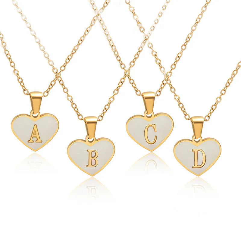 Gold plated heart pendant necklace with white shell centre and personalised letter engraving on adjustable chain