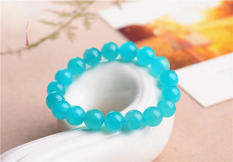 Grade 7A Amazonite natural scattered beads in ice blue and green, showing polished round and three-ring bead styles for bracelet making.