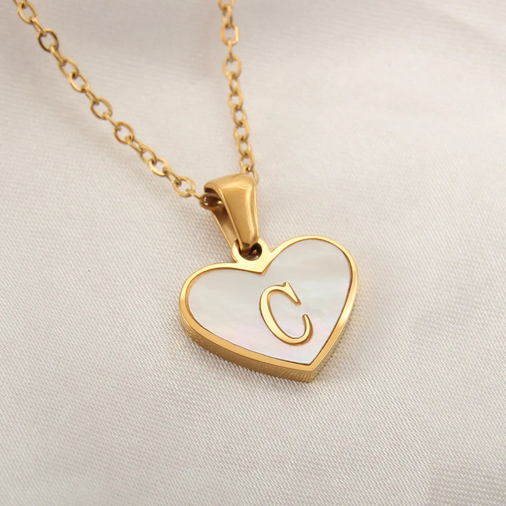 Gold plated heart pendant necklace with white shell centre and personalised letter engraving on adjustable chain