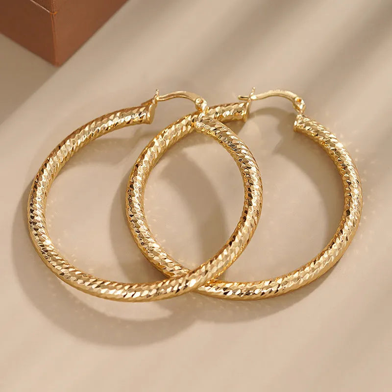 Geometric copper ear clip earrings with ring design detail and electroplated finish