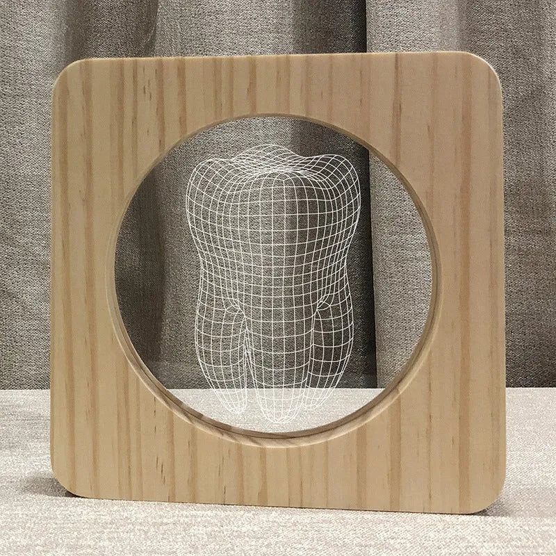 Wood-colour tooth-shaped acrylic USB night lamp on a surface