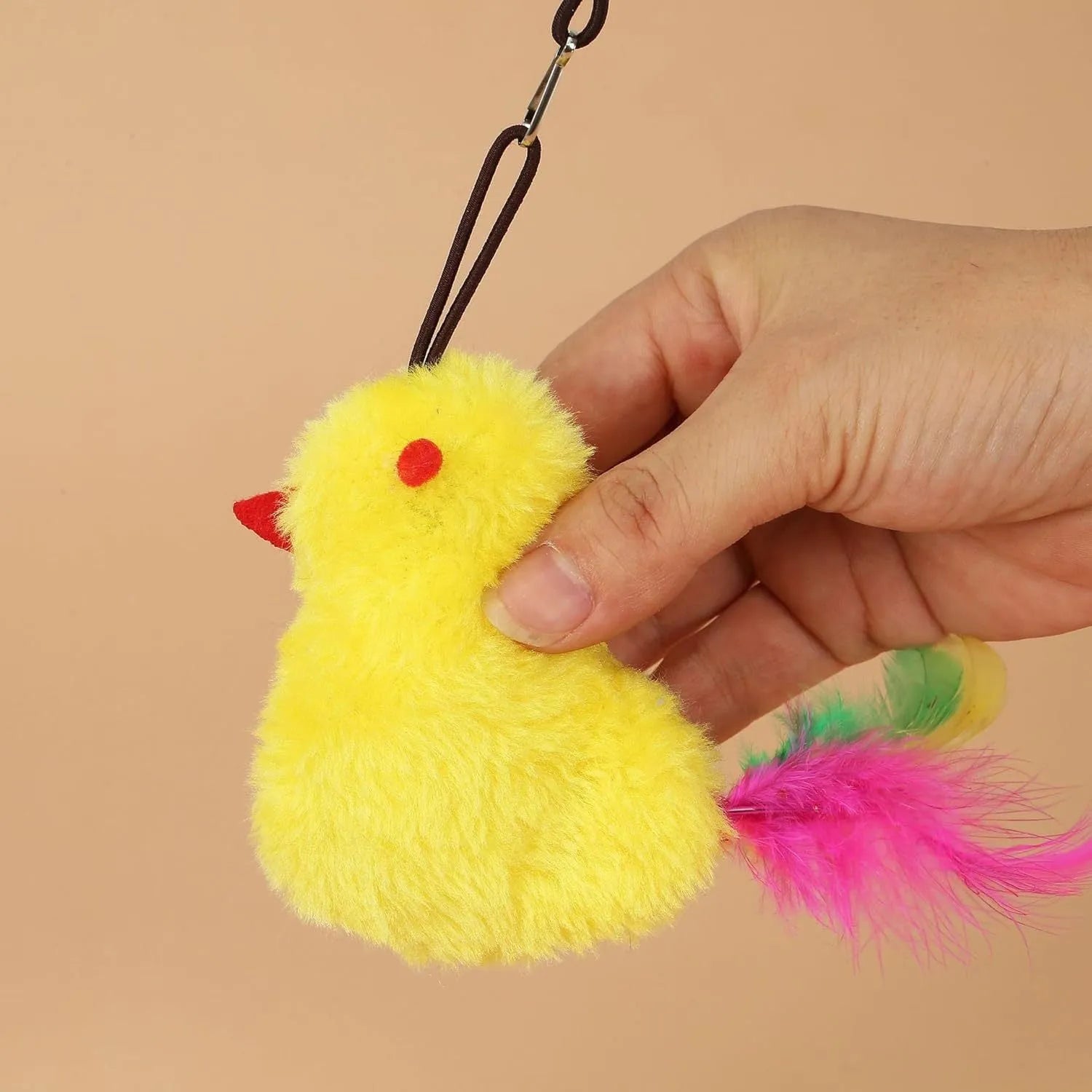 Grey and yellow interactive cat toy with swinging mouse, sound response, and treat dispenser on retractable cord