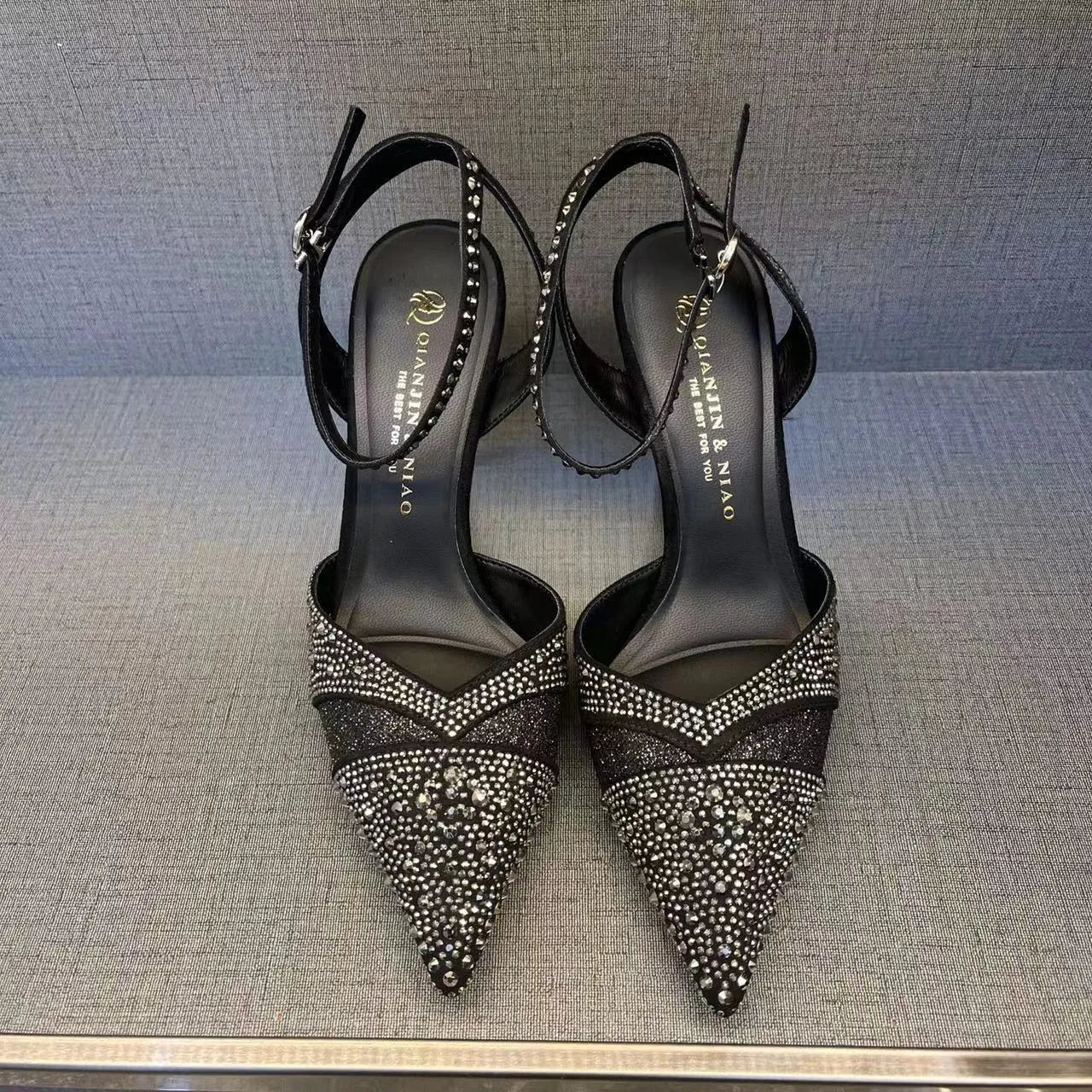 Women's silver and black hollow high heels with red sole and pointed stiletto heel