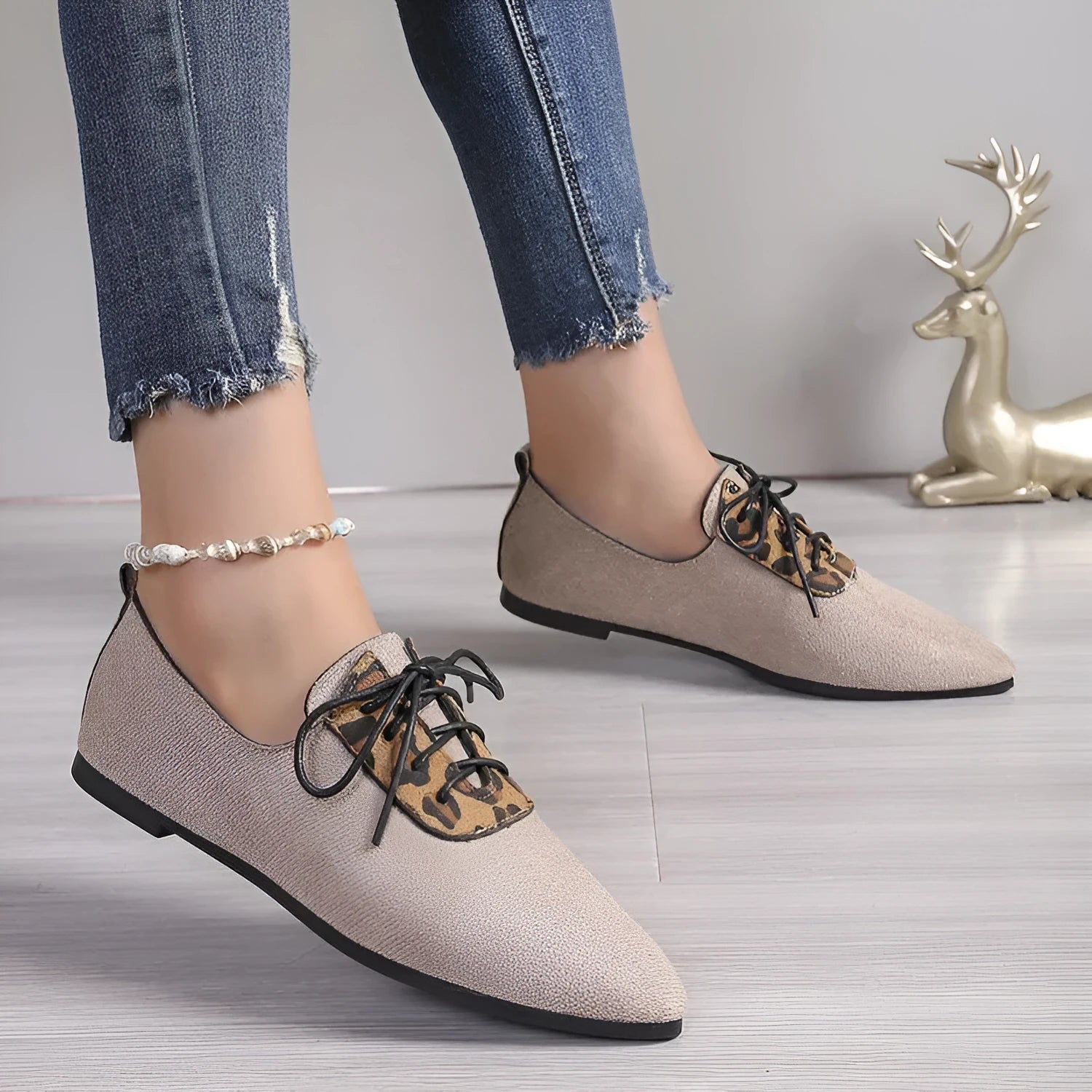 Beige leopard print women's pointed toe high heel pumps with a rubber sole.